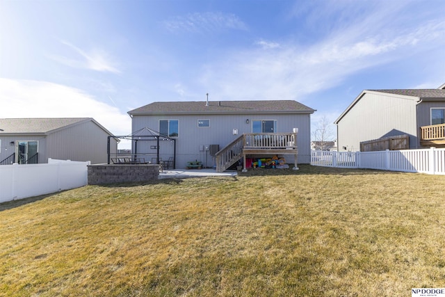 rear view of property featuring a gazebo, a deck, a patio, and a yard