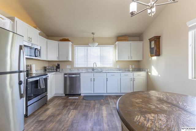 kitchen featuring sink, white cabinetry, appliances with stainless steel finishes, and lofted ceiling