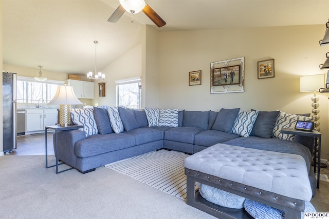 carpeted living room featuring lofted ceiling, ceiling fan with notable chandelier, and sink