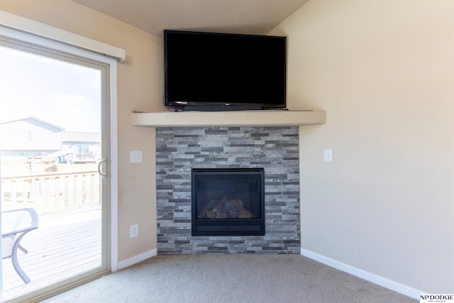 room details featuring carpet floors and a tile fireplace