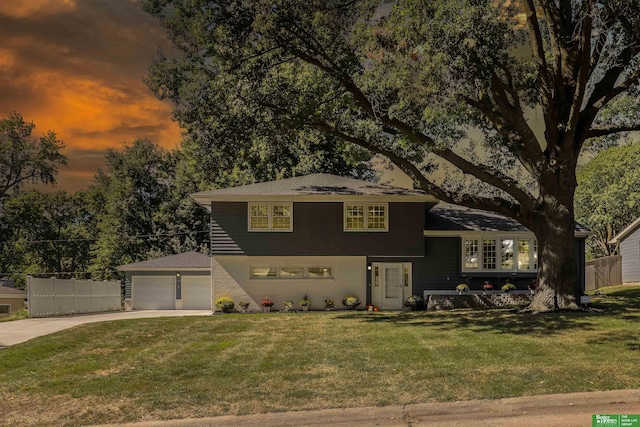 view of front of house featuring a lawn and a garage