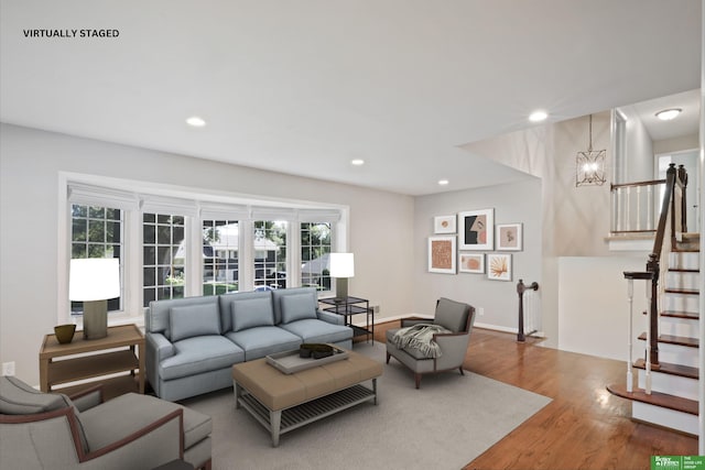 living room featuring hardwood / wood-style flooring, a chandelier, and plenty of natural light