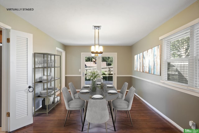 dining space with dark hardwood / wood-style flooring