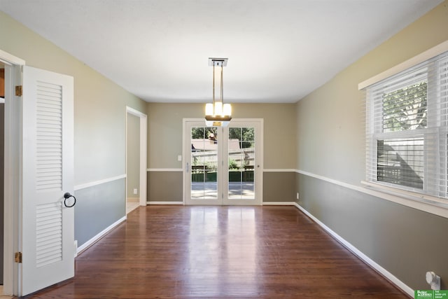 unfurnished dining area with french doors and dark wood-type flooring