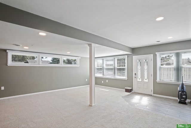 entryway featuring light carpet