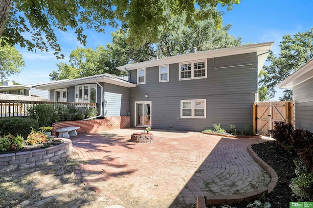 back of house featuring a patio area and a fire pit