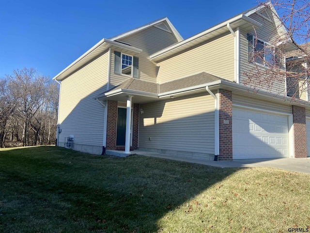 view of front of home with a front lawn and a garage