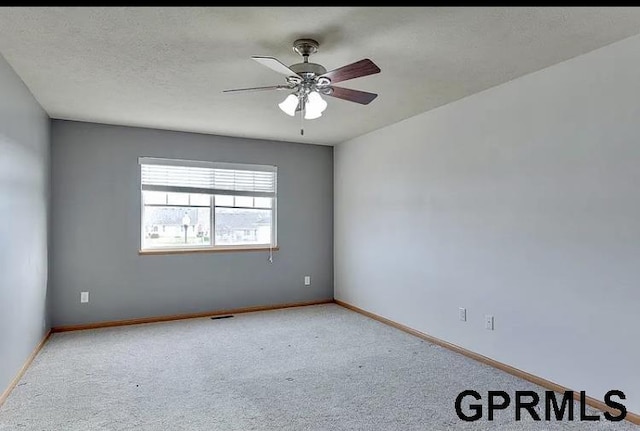 spare room featuring ceiling fan and light colored carpet