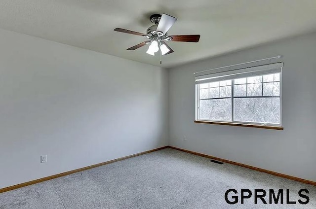 carpeted empty room featuring ceiling fan