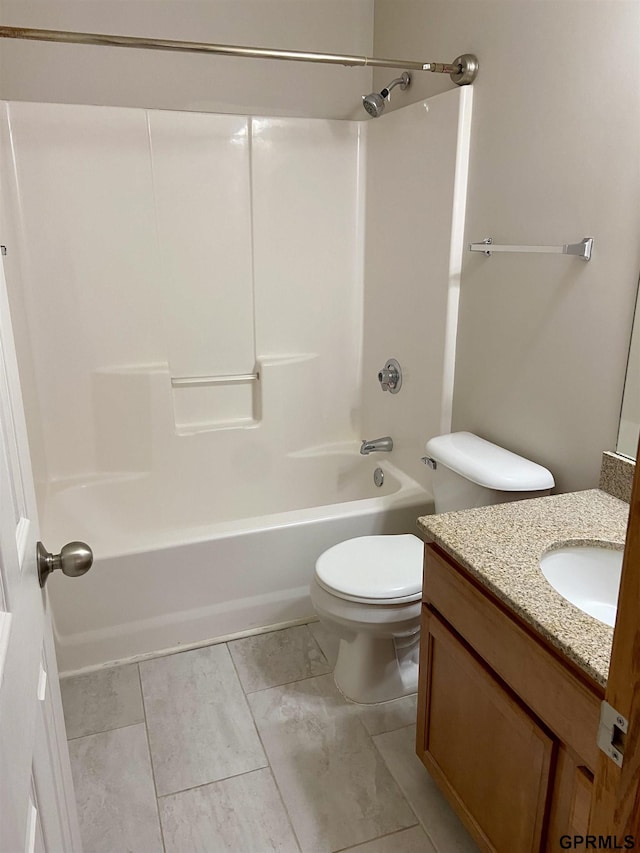 full bathroom featuring tile patterned floors, washtub / shower combination, vanity, and toilet