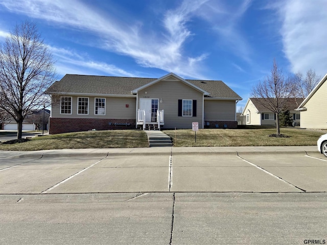 ranch-style home with a front lawn