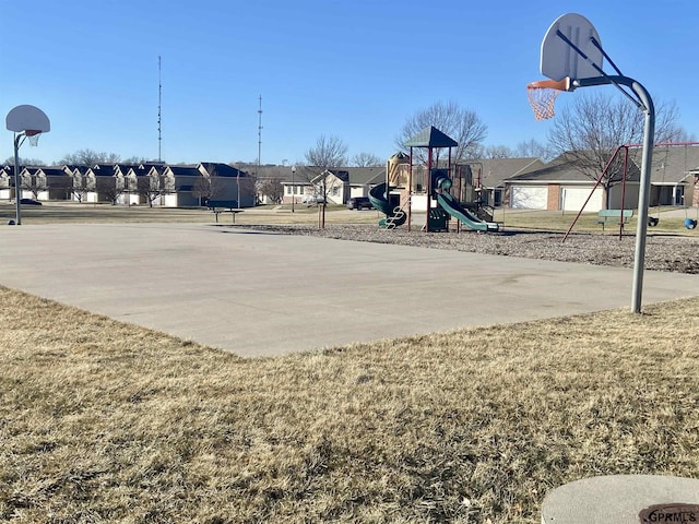 view of sport court featuring a playground and a lawn