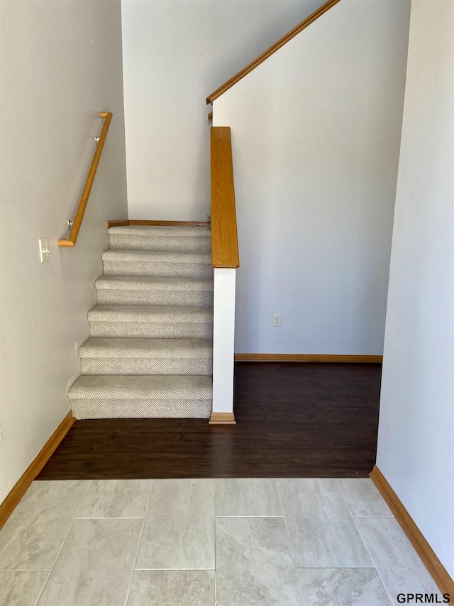 stairway with tile patterned flooring