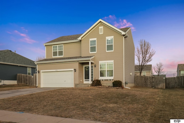 view of property featuring a garage and a yard