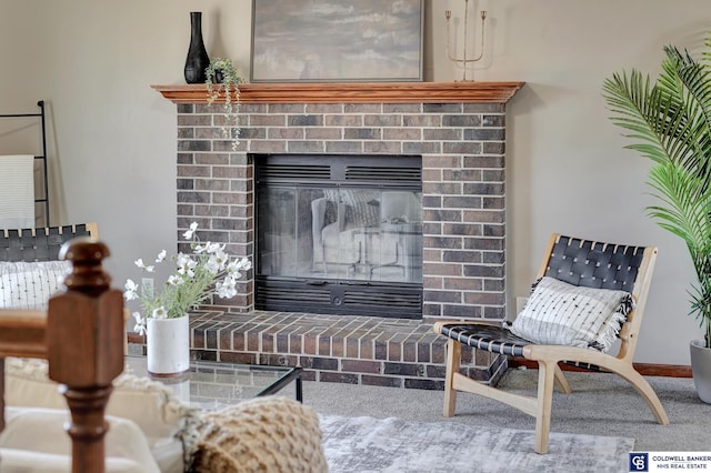 living area featuring carpet floors and a brick fireplace