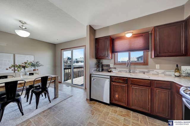 kitchen with sink, a wealth of natural light, and appliances with stainless steel finishes