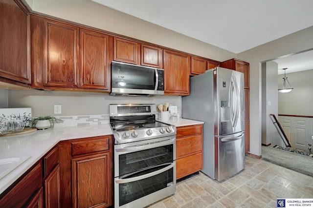 kitchen with hanging light fixtures and appliances with stainless steel finishes