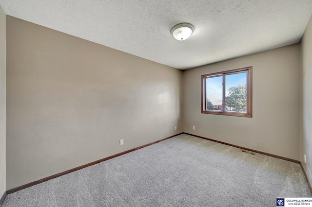 unfurnished room featuring carpet floors and a textured ceiling