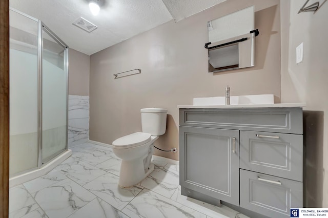 bathroom with a textured ceiling, walk in shower, vanity, and toilet