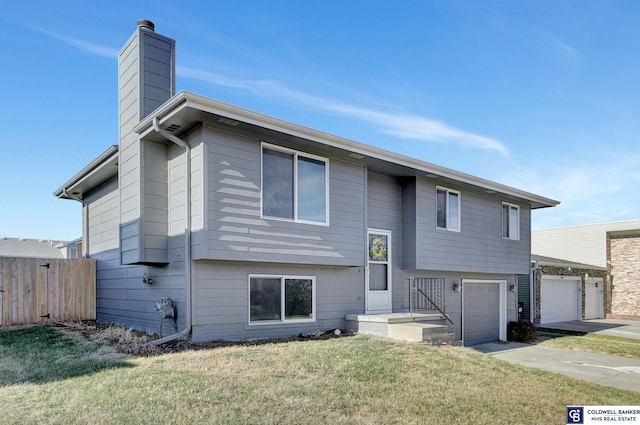 view of front of property with a front lawn and a garage