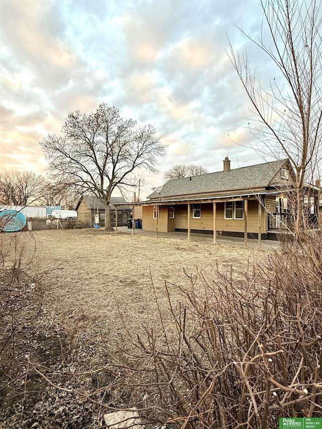 view of back house at dusk