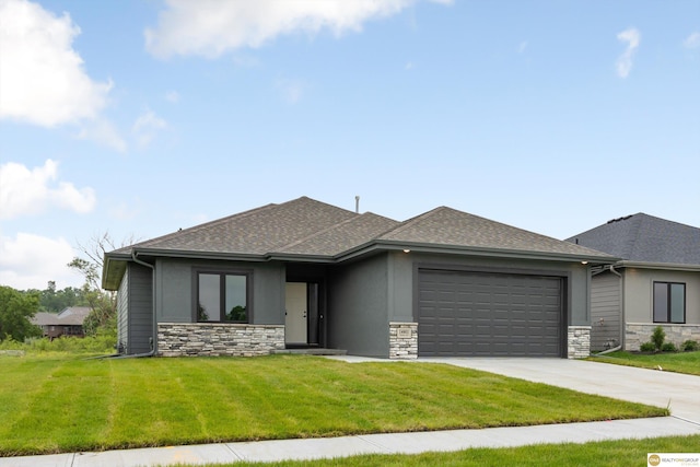 prairie-style home with a front yard and a garage