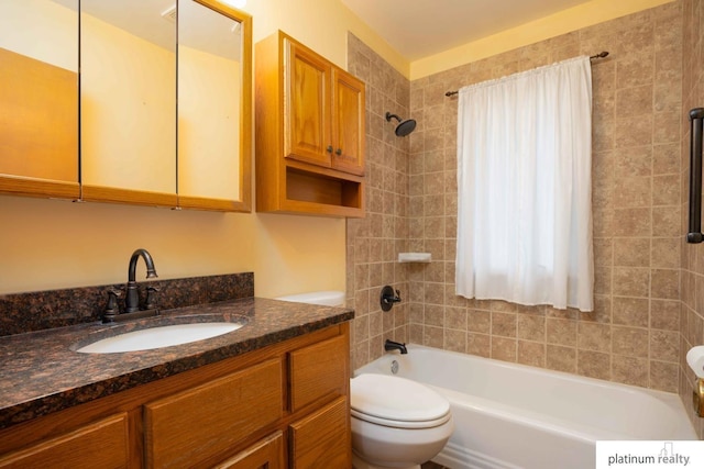 full bathroom with tiled shower / bath combo, vanity, and toilet