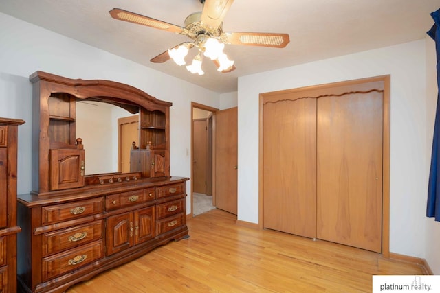 bedroom with light hardwood / wood-style flooring, a closet, and ceiling fan