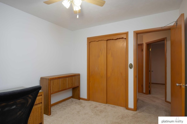 carpeted bedroom with ceiling fan and a closet