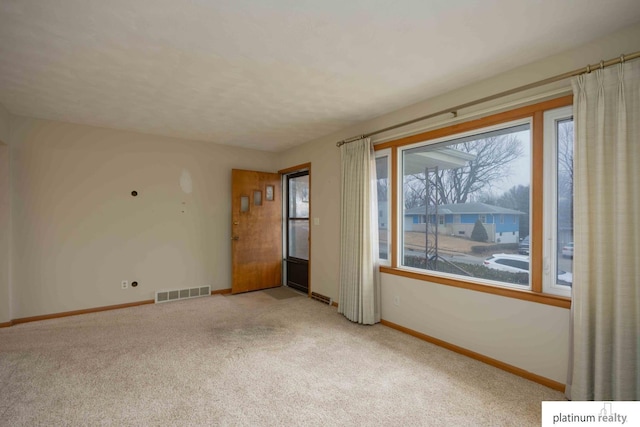 empty room featuring light carpet