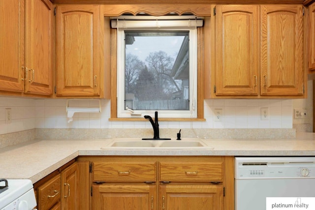 kitchen featuring tasteful backsplash, sink, dishwasher, and range