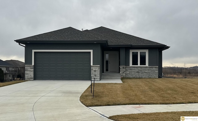 prairie-style house featuring a front yard and a garage