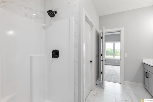 bathroom featuring a shower and vanity