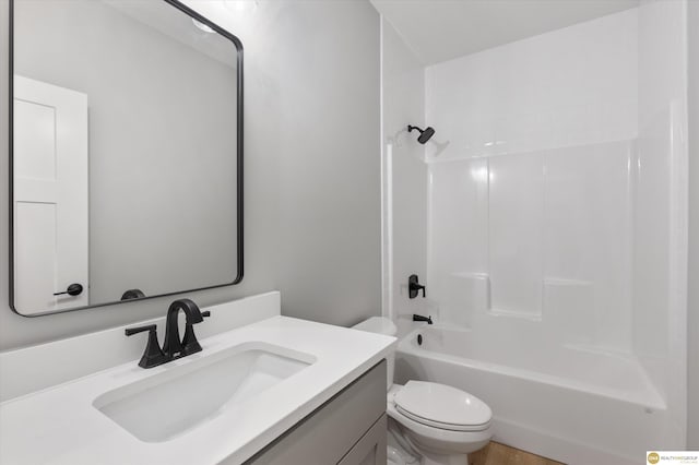 full bathroom featuring shower / bathing tub combination, vanity, and toilet