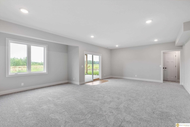 unfurnished room featuring light colored carpet