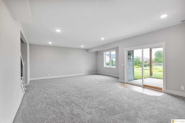 unfurnished living room with light colored carpet