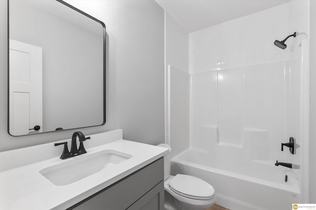 full bathroom featuring toilet, vanity, and bathtub / shower combination