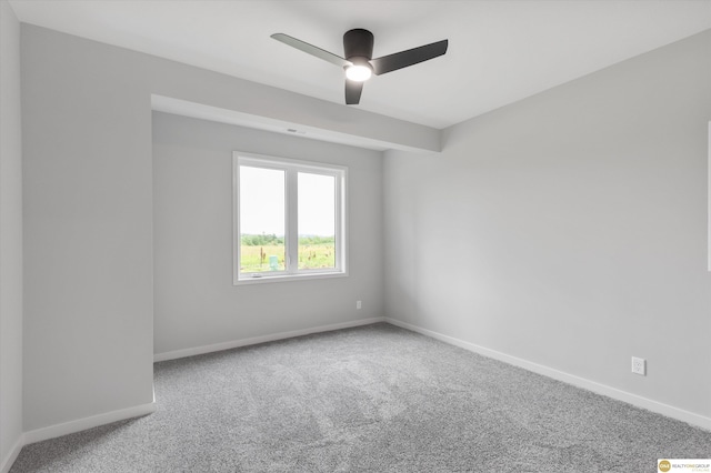 carpeted spare room featuring ceiling fan