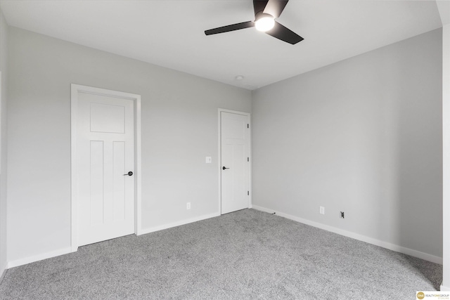 unfurnished bedroom with ceiling fan and carpet