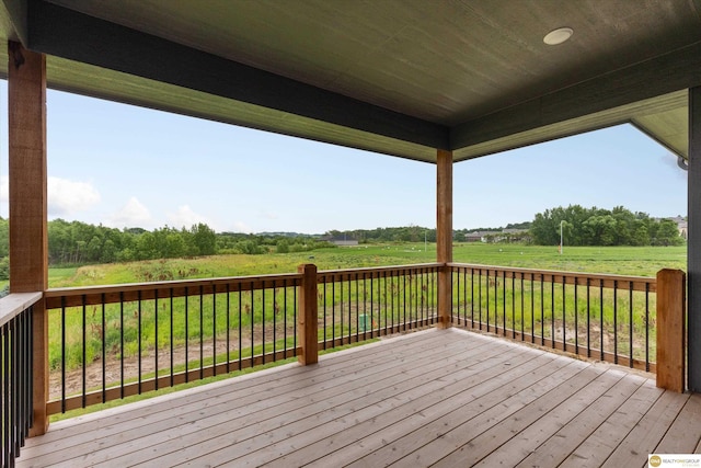 wooden deck with a rural view