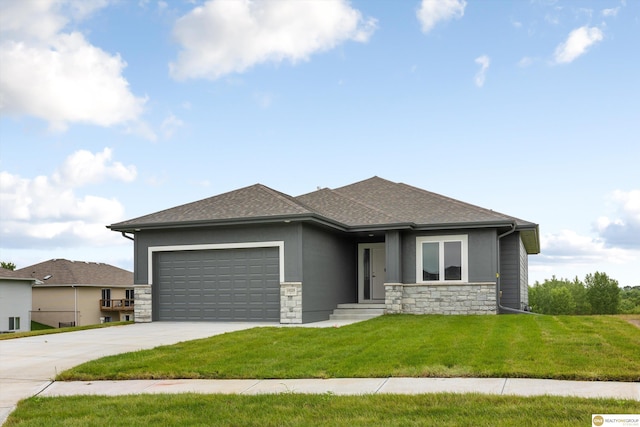 prairie-style home with a garage and a front yard