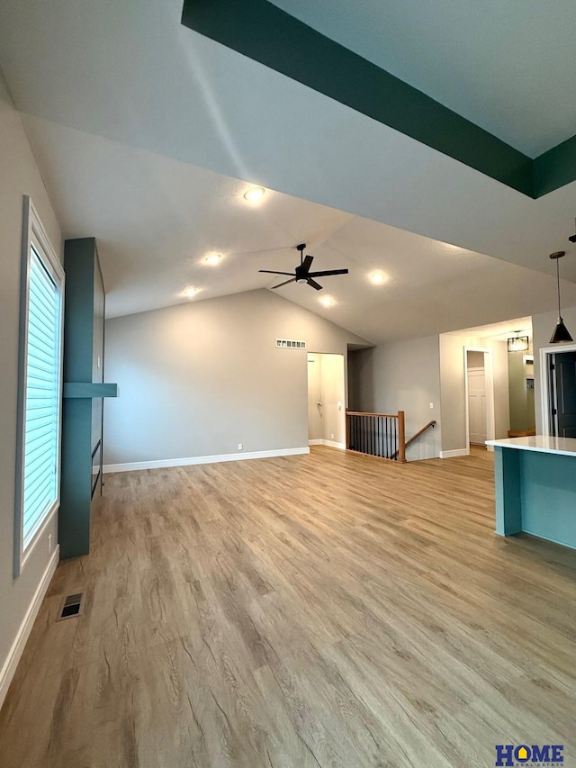 unfurnished living room featuring ceiling fan, light wood-type flooring, and lofted ceiling