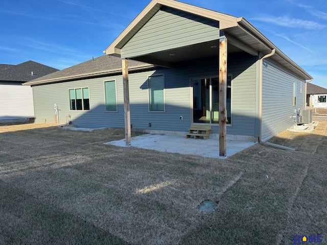 rear view of house with a patio area and central AC unit