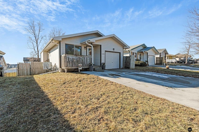 ranch-style home with a front yard, covered porch, and a garage