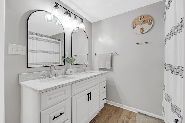 bathroom featuring vanity, a textured ceiling, and hardwood / wood-style floors