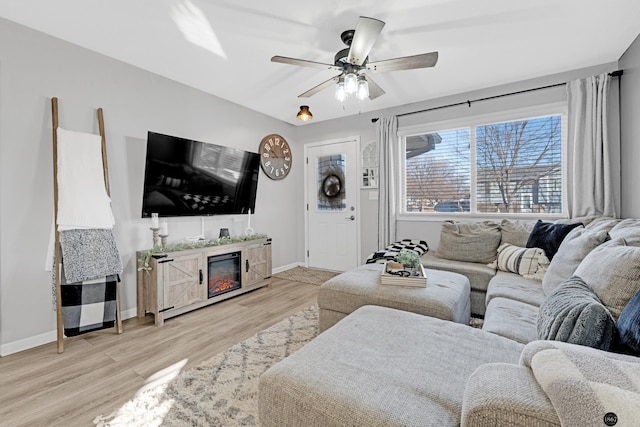 living room with light hardwood / wood-style floors and ceiling fan