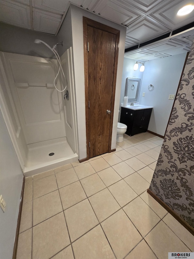 bathroom with toilet, a shower, tile patterned floors, and vanity