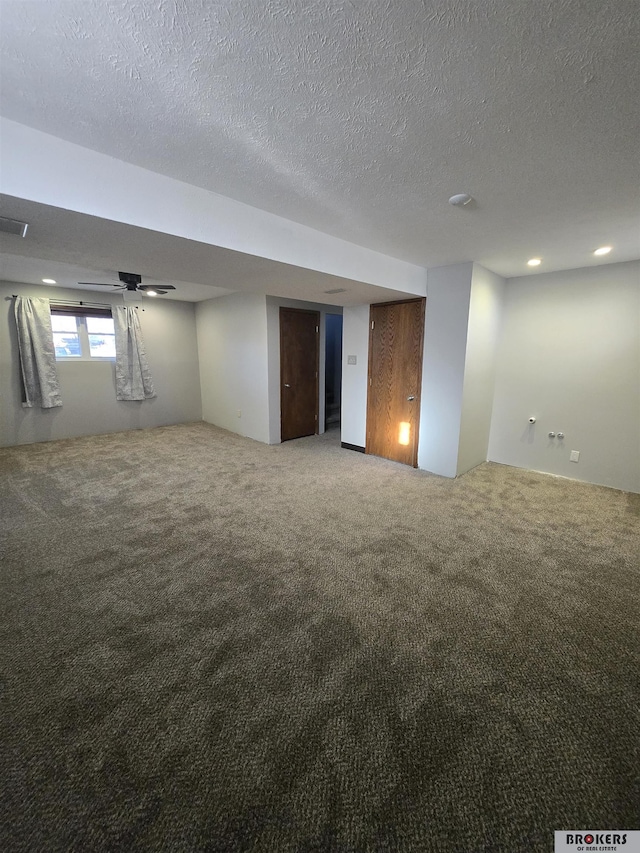 basement with carpet and a textured ceiling