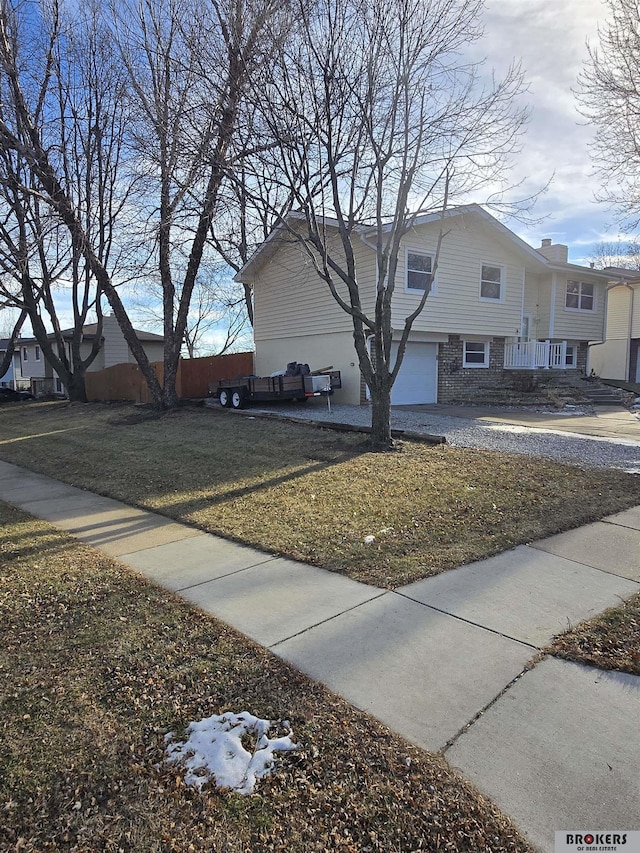 view of side of home featuring a garage and a yard