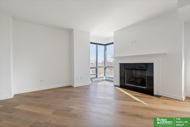 unfurnished living room featuring hardwood / wood-style floors